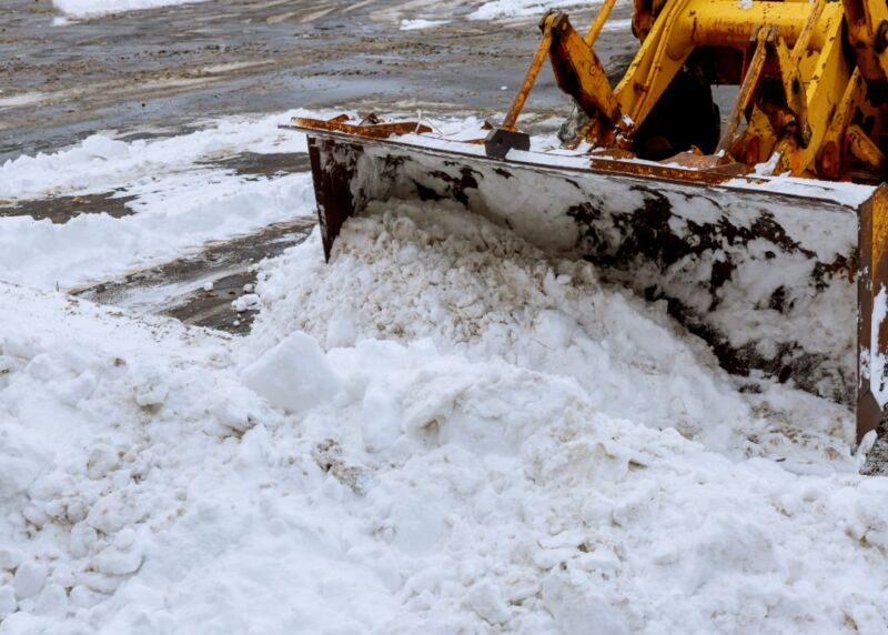 closeup-grader-cleaning-snow-covered-road.jpg
