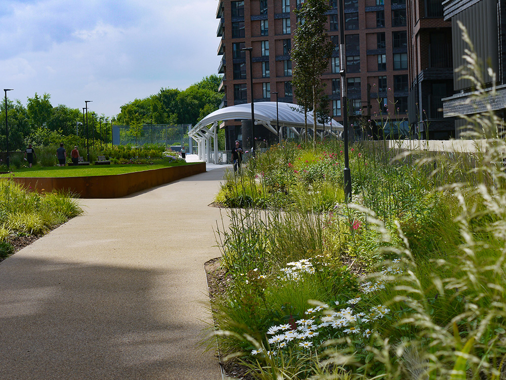 Regenerated public viaduct walkway with community green spaces and soft landscaping surrounding
